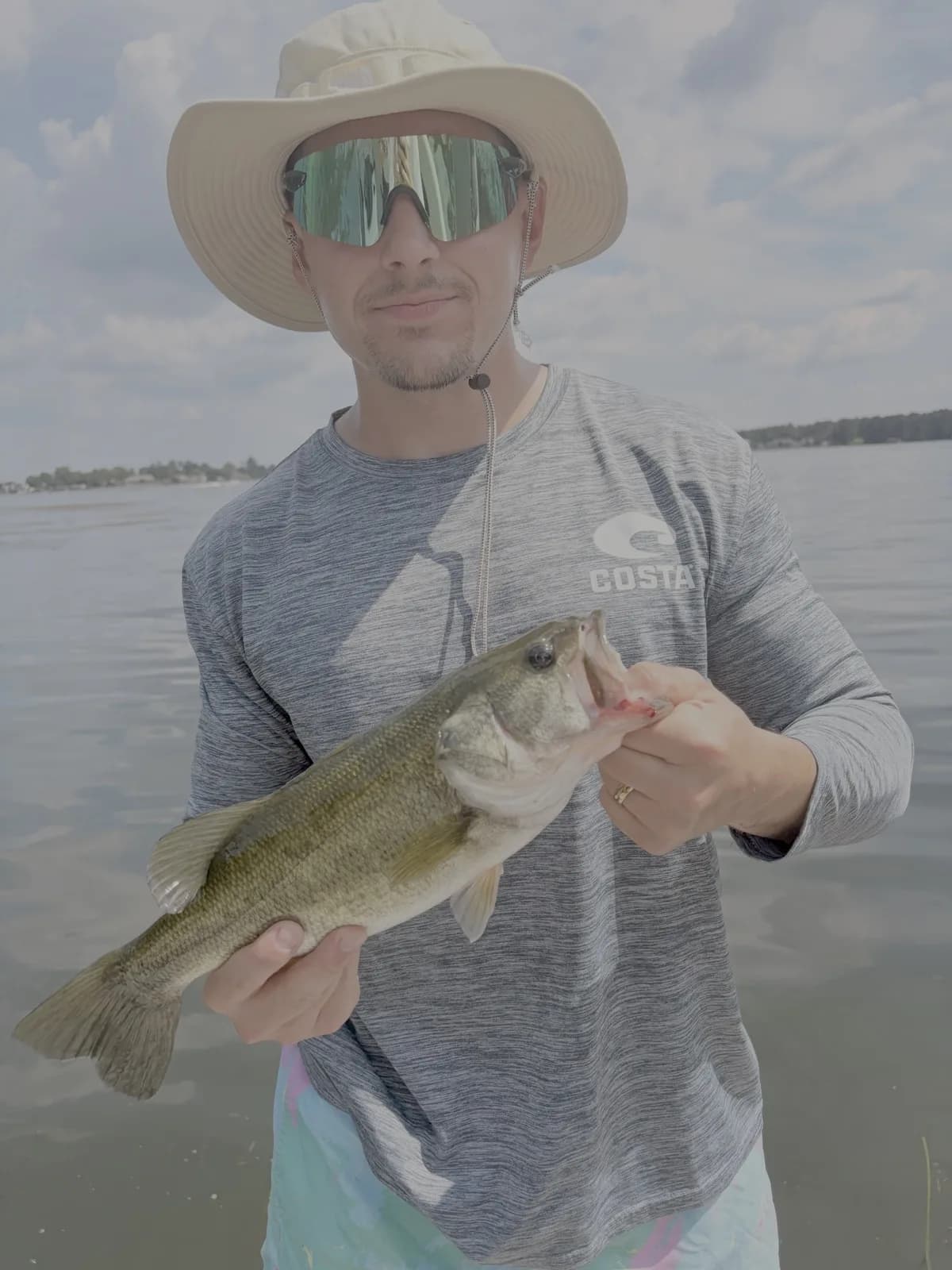 Me holding a largemouth bass on the lake